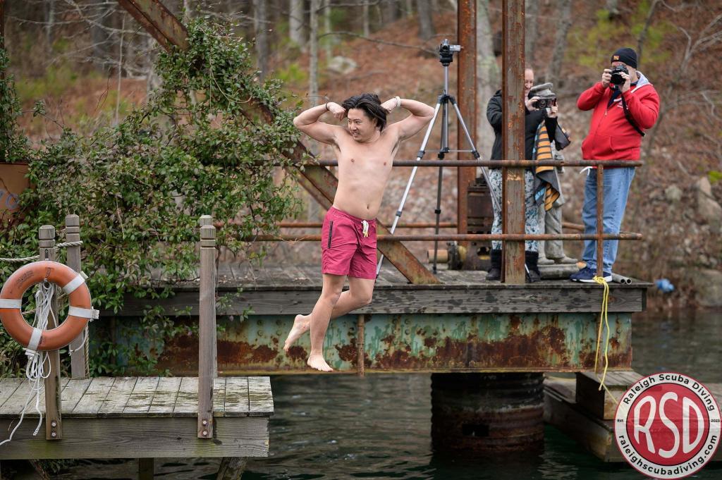 Instructor jumping into water for the 2024 DUDC Polar Plunge